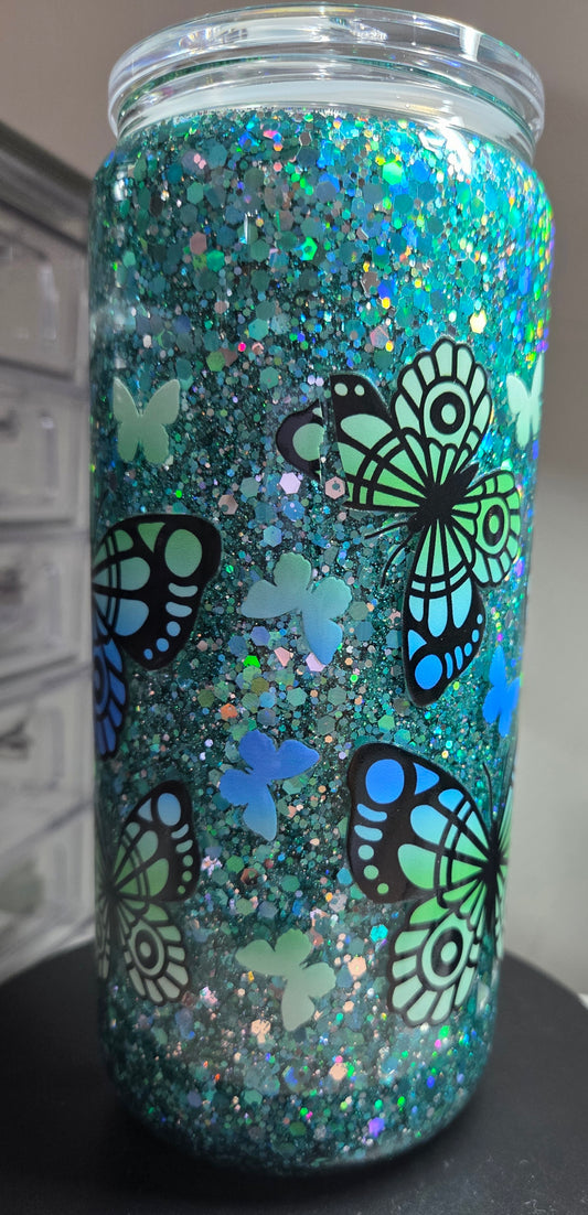 16oz Glass snowglobe with butterfly wrap. Small part of wrap came off.